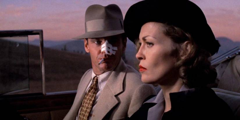 Jack Nicholson and Faye Dunaway talking in a car with the top down in Chinatown.