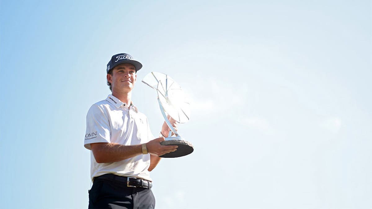 Jackson Koivun of the United States poses with the Elemental Swing trophy
