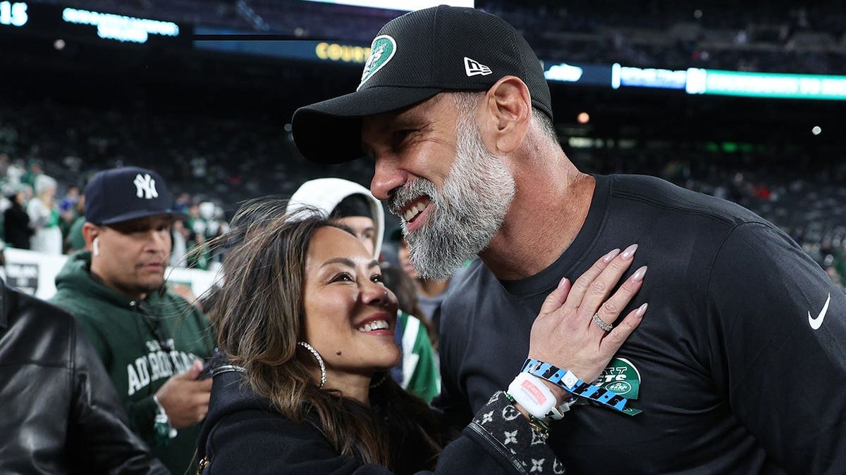 Jeff Ulbrich and his wife Cristina embrace at MetLife Stadium before a game.