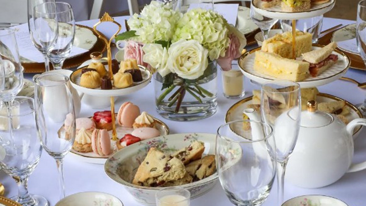 Pastries are shown on a table with a flower arrangement.