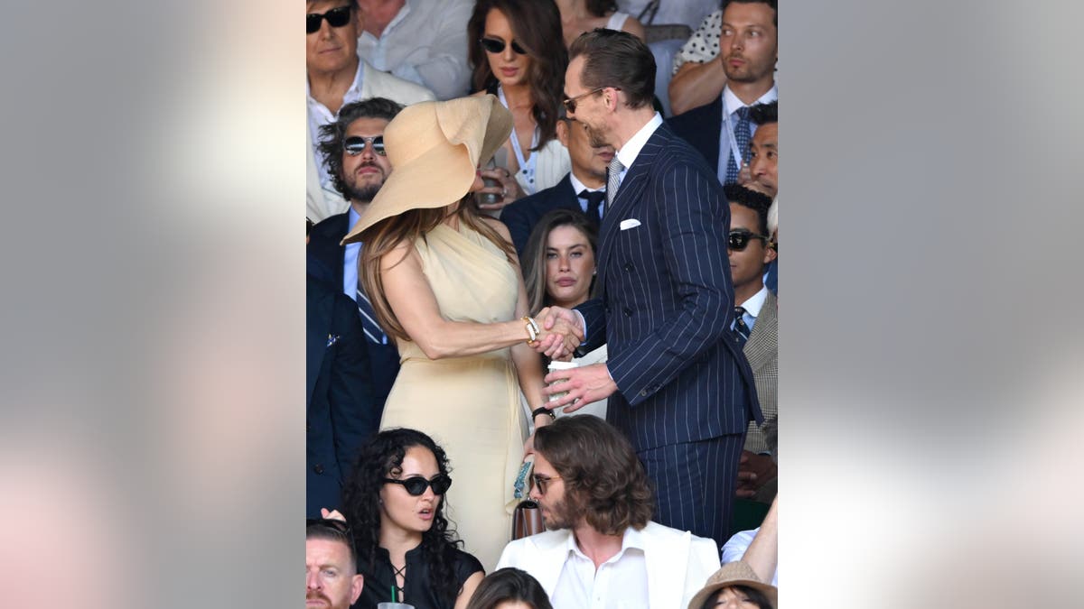 Jennifer Lopez and Tom Hiddleston stand together at Wimbledon.
