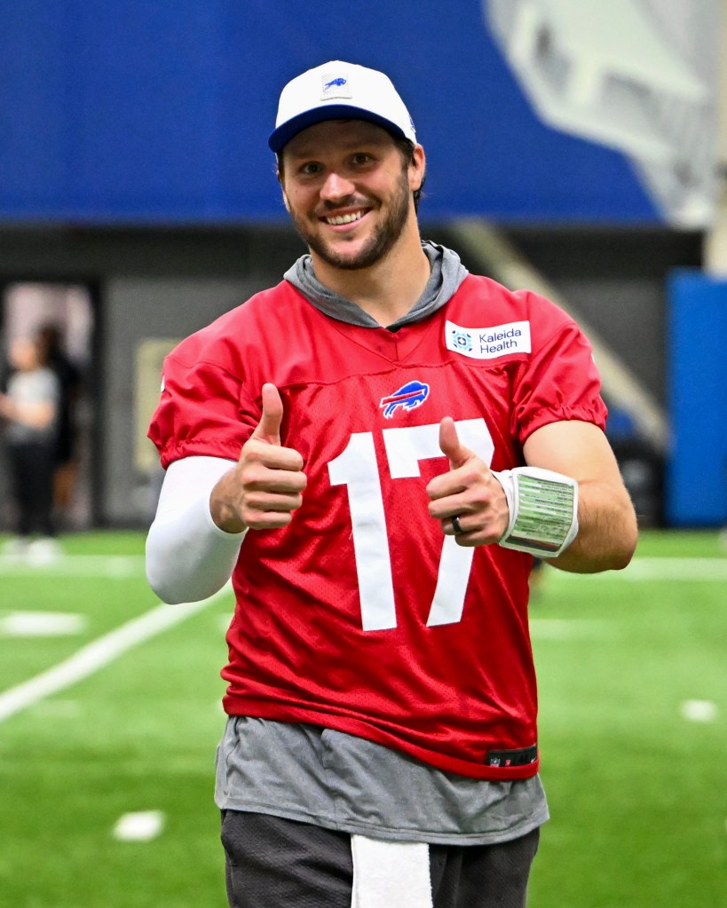 Buffalo Bills quarterback Josh Allen smiling and giving two thumbs up.