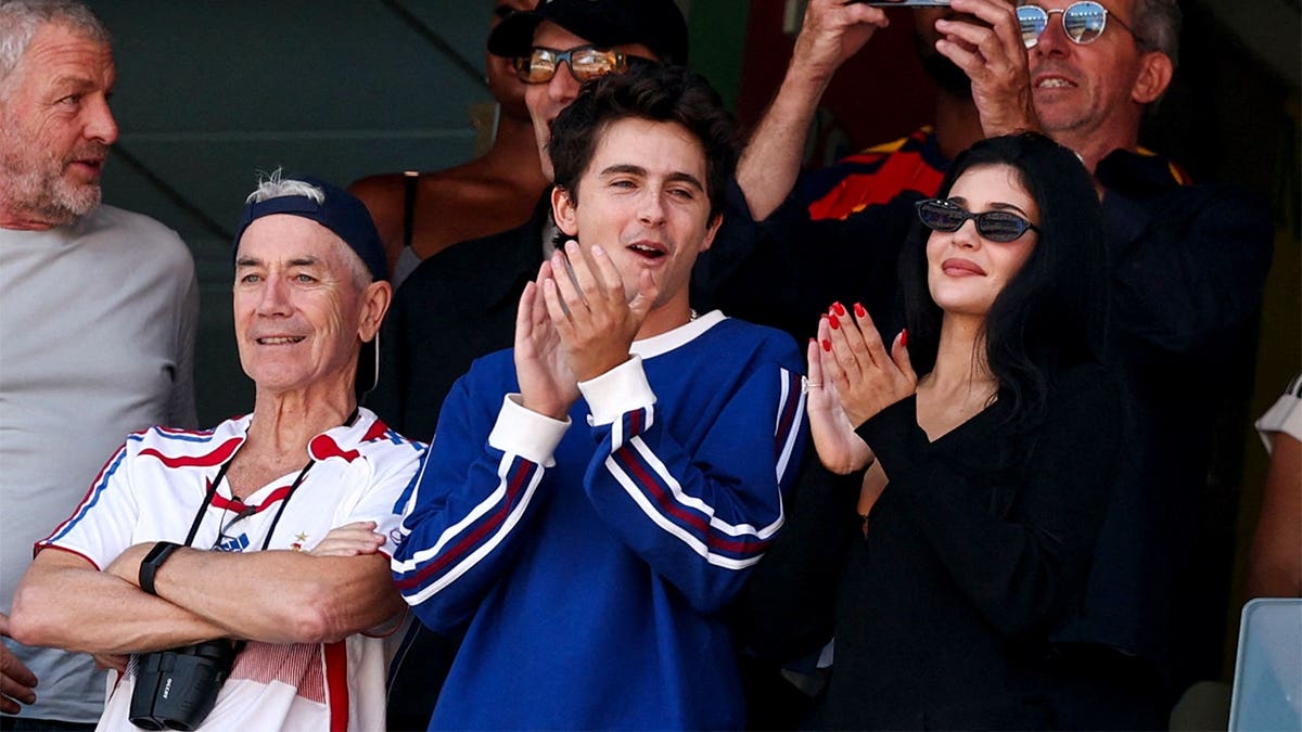 French-US actor Timothee Chalamet (C), US Media personality Kylie Jenner (R), and Marc Chalamet (L) attend the 2026 World Cup football tournament final match between Spain and Argentina