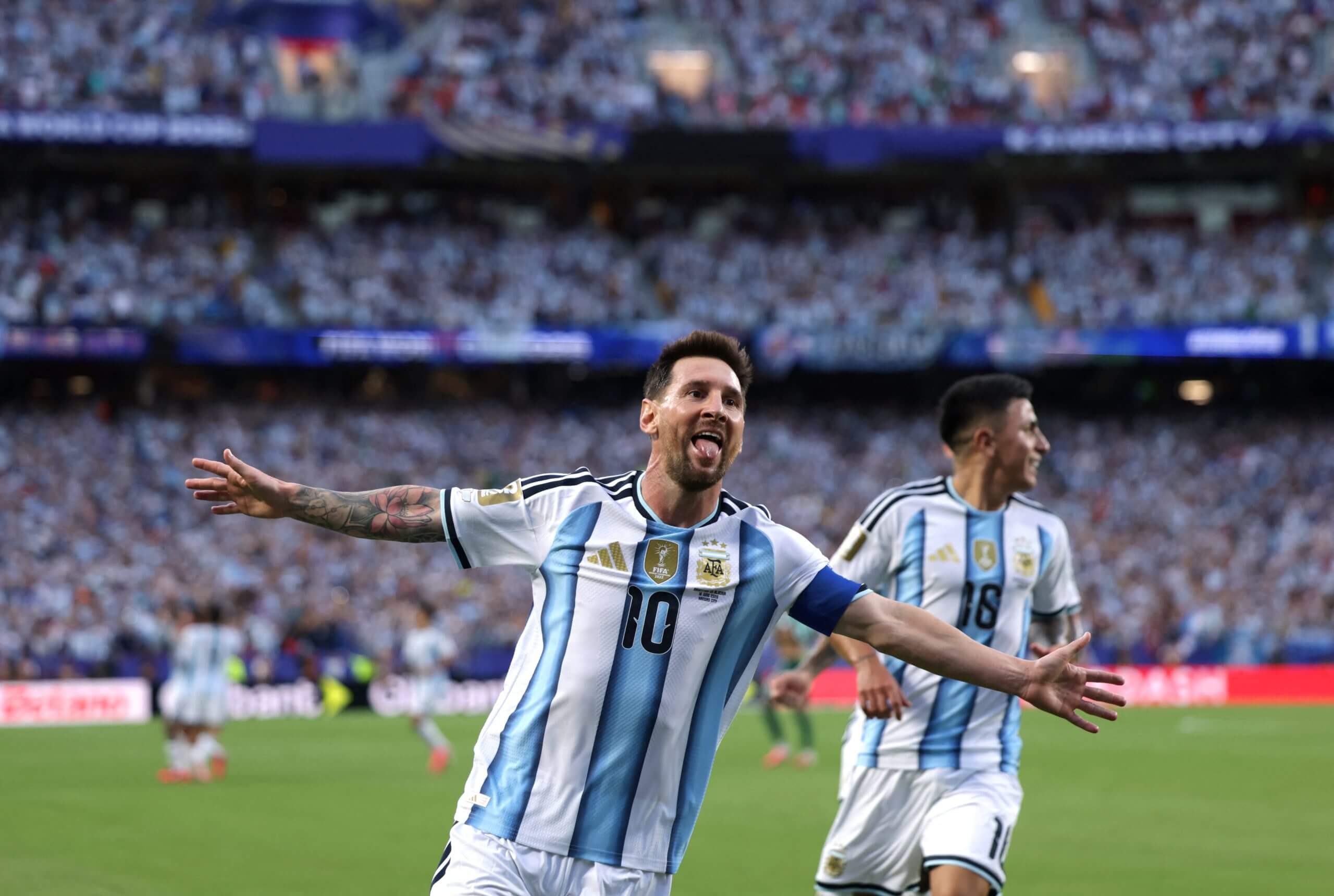 Messi celebrating with his arms outstretched
