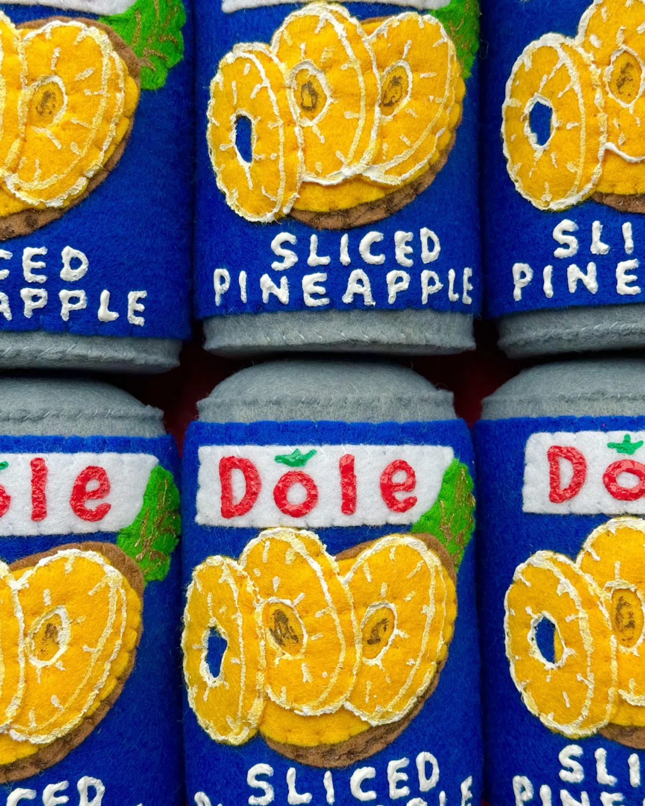 Dole cans of pineapple slices reimagined in felt by artist Lucy Sparrow