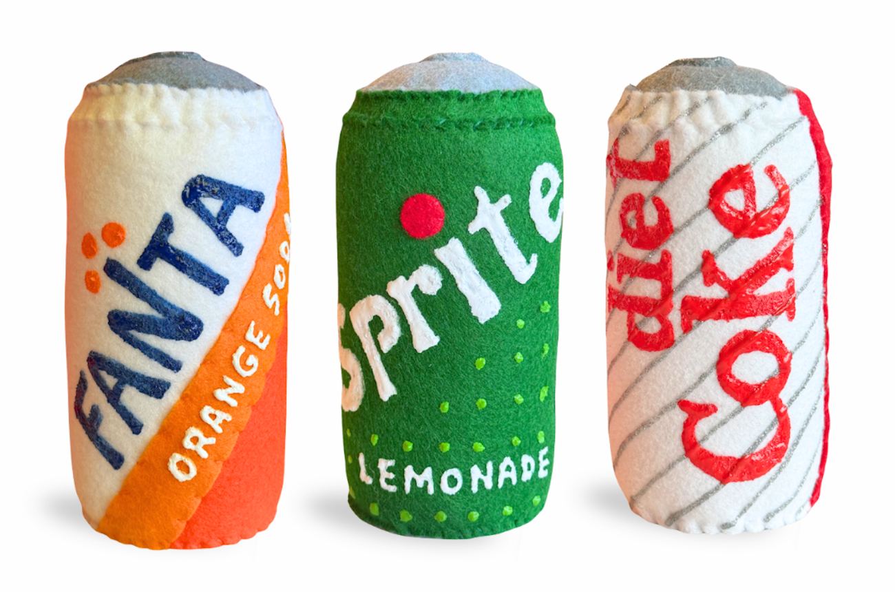 Fanta, Sprite, and Diet Coke cans reimagined in felt by artist Lucy Sparrow