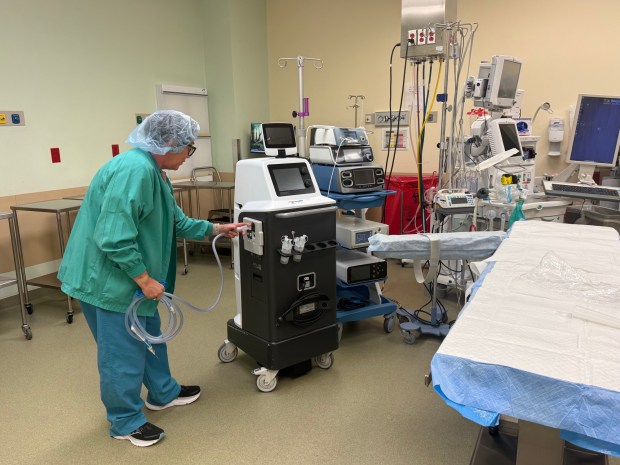 Nurse Debbie Morrison, manager of surgical services at Sentara Williamsburg Medical Center, works with the smoke evacuation system in an operating room. (Skylar Hartgerink/The Virginia Gazette)