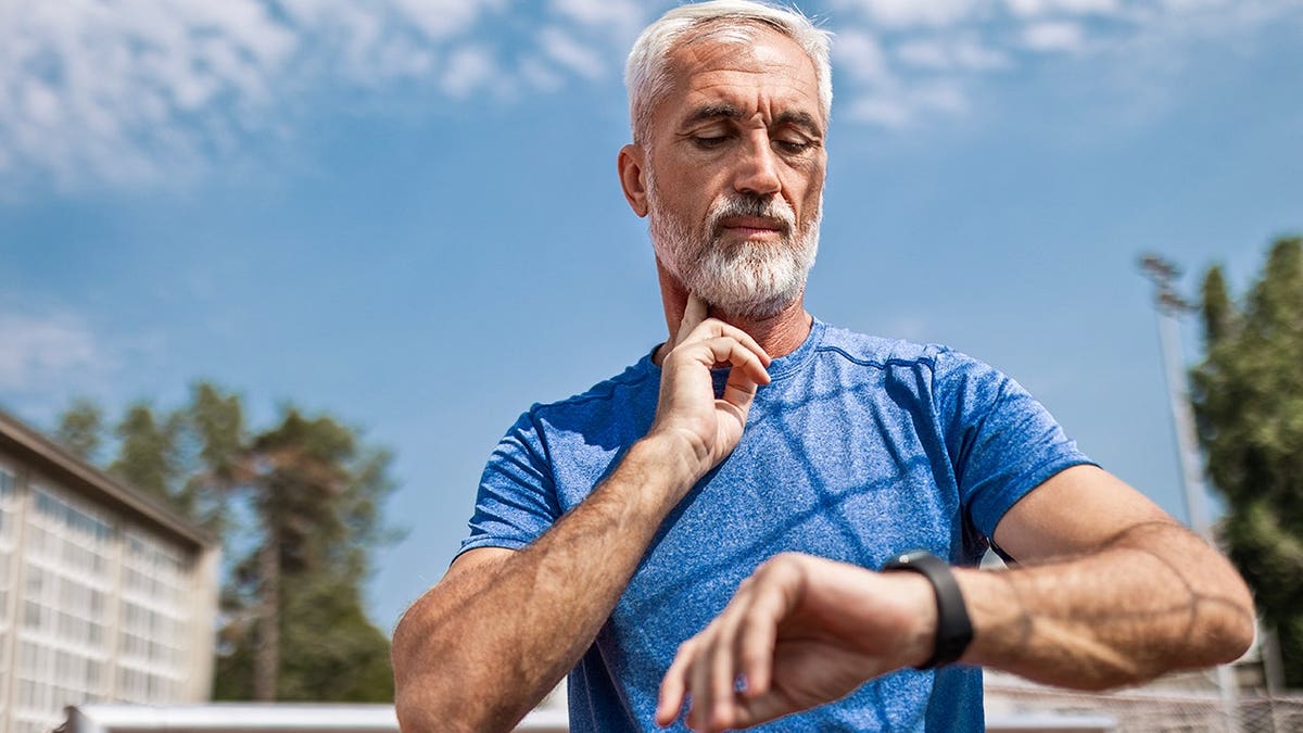 Senior athlete checks pulse