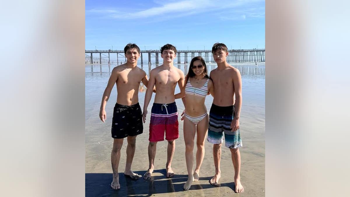 Maria Kang with sons on beach