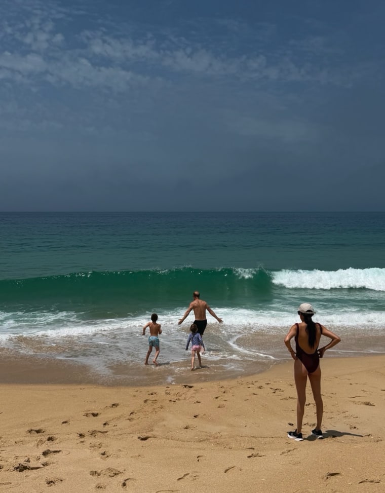 Meghan Markle watching her family play in the ocean.