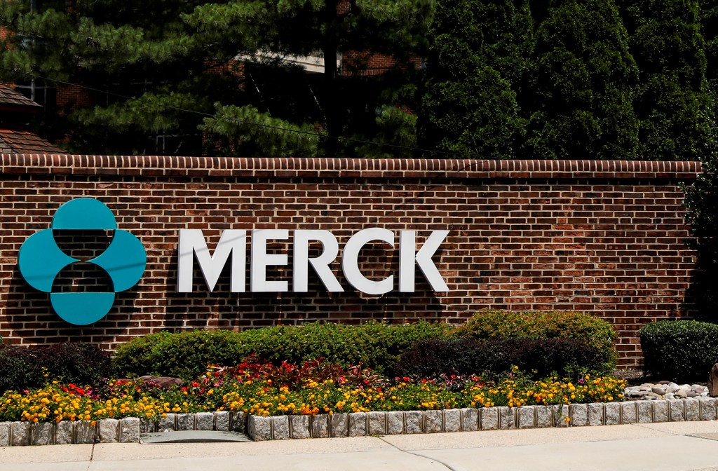 The Merck logo and company name on a brick wall at the entrance to the campus.