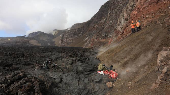 On July 2, three USGS Hawaiian Volcano Observatory scientists flew via helicopter to the northwest side of Halema‘uma‘u at the summit of Kīlauea to sample tephra deposits in the crater wall. These deposits were exposed by the 2018 summit collapse, but lava flows from the ongoing episodic Kīlauea summit eruption are likely to bury them again in the near future.