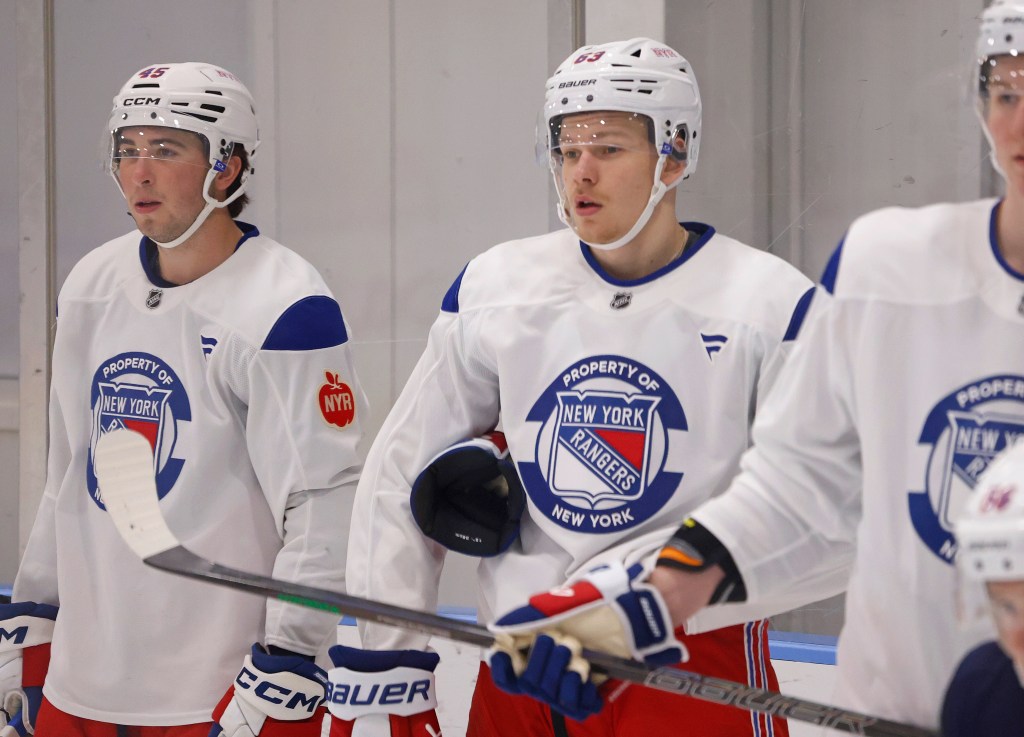 New York Rangers Development Camp players Drew Fortescue and Alberts Smits in white jerseys.