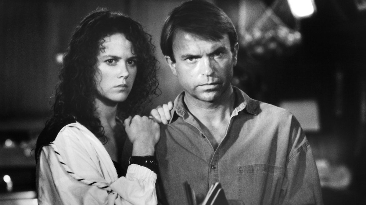 A black and white photo of Nicole Kidman and Sam Neill on set of 