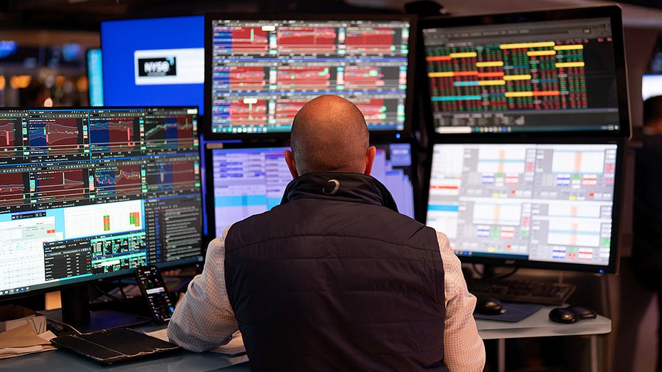 A trader works on the floor of the NYSE.