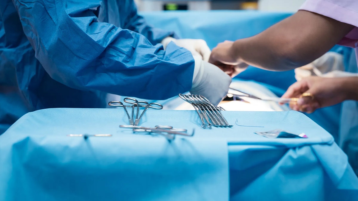 surgeon conduct procedure on operation table