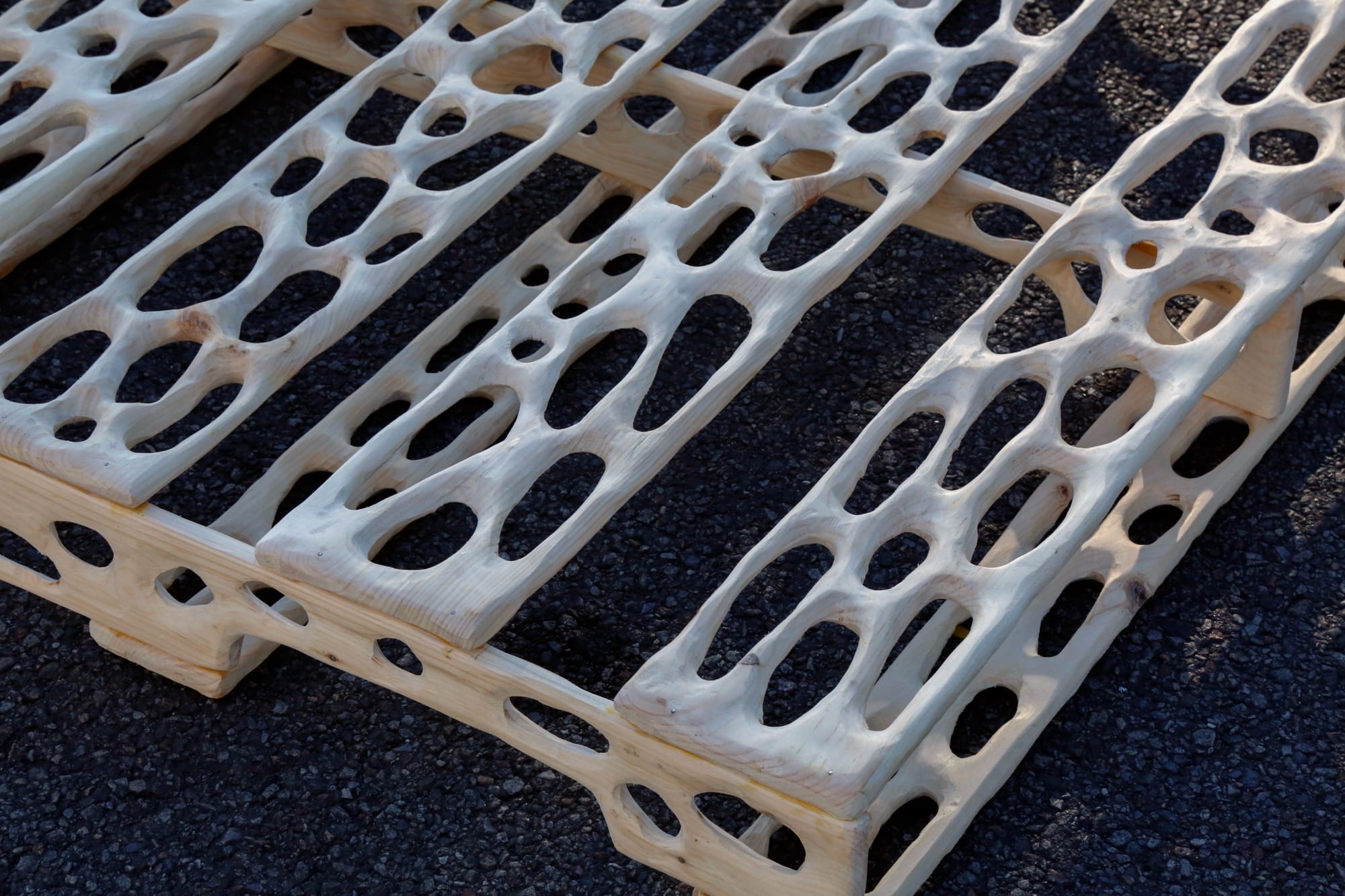 a detail image of a carved wood palette with irregularly shaped holes