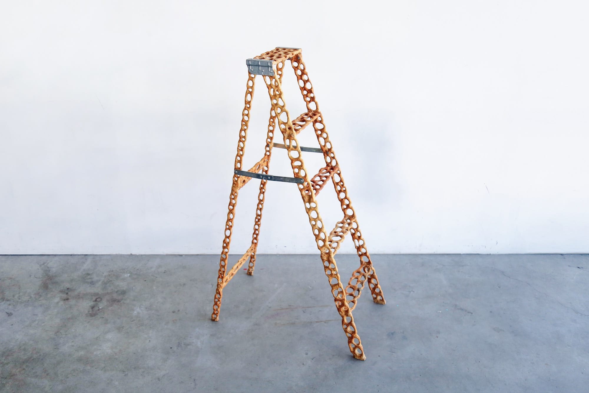 a carved wood ladder with irregularly shaped holes