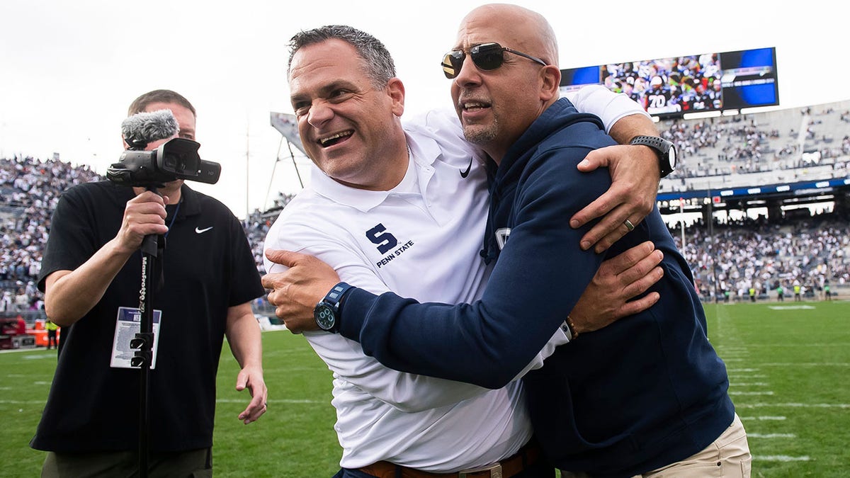 Pat Kraft and James Franklin hugs