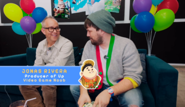 Jonas Rivera sits on a couch in front of multicolored balloons.