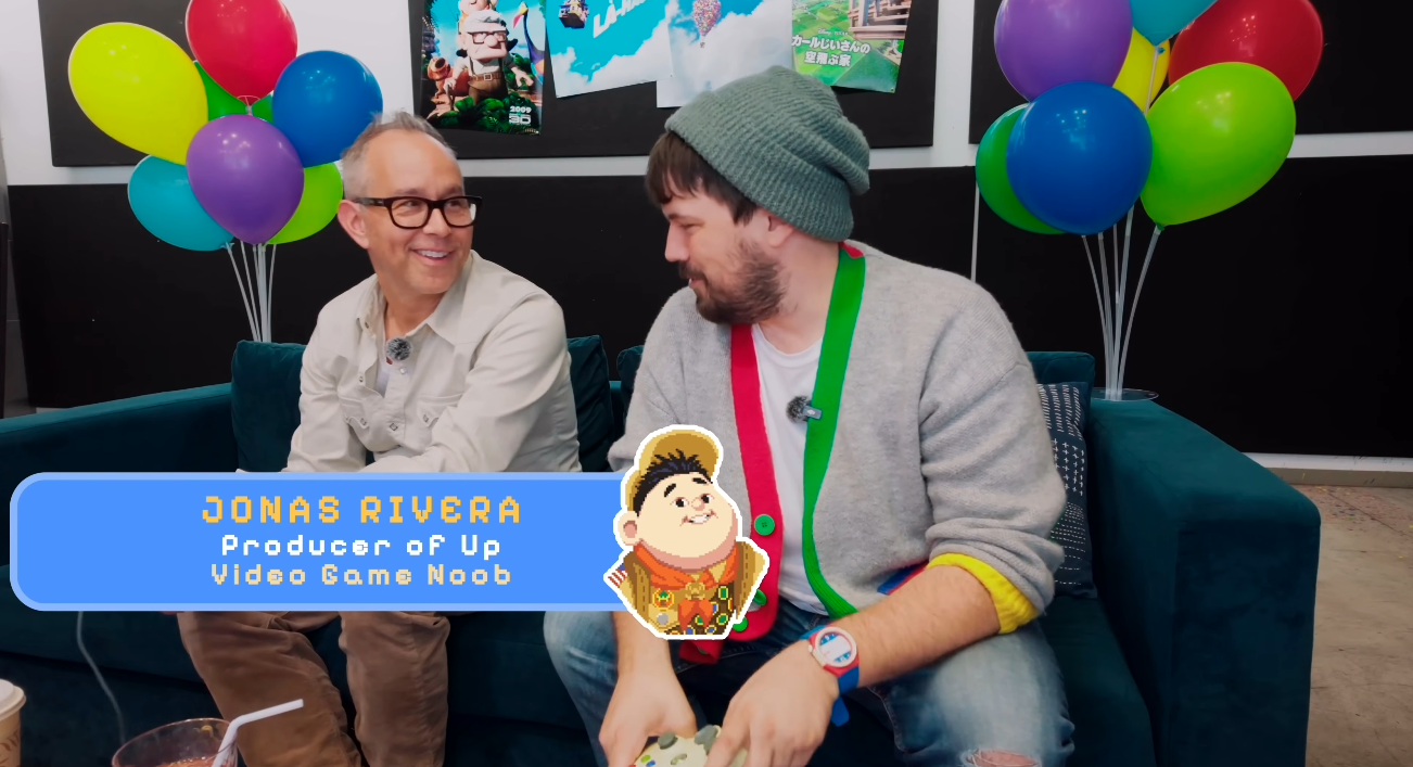Jonas Rivera sits on a couch in front of multicolored balloons.