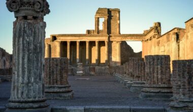 The sun rises over colonnade ruins at Pompeii
