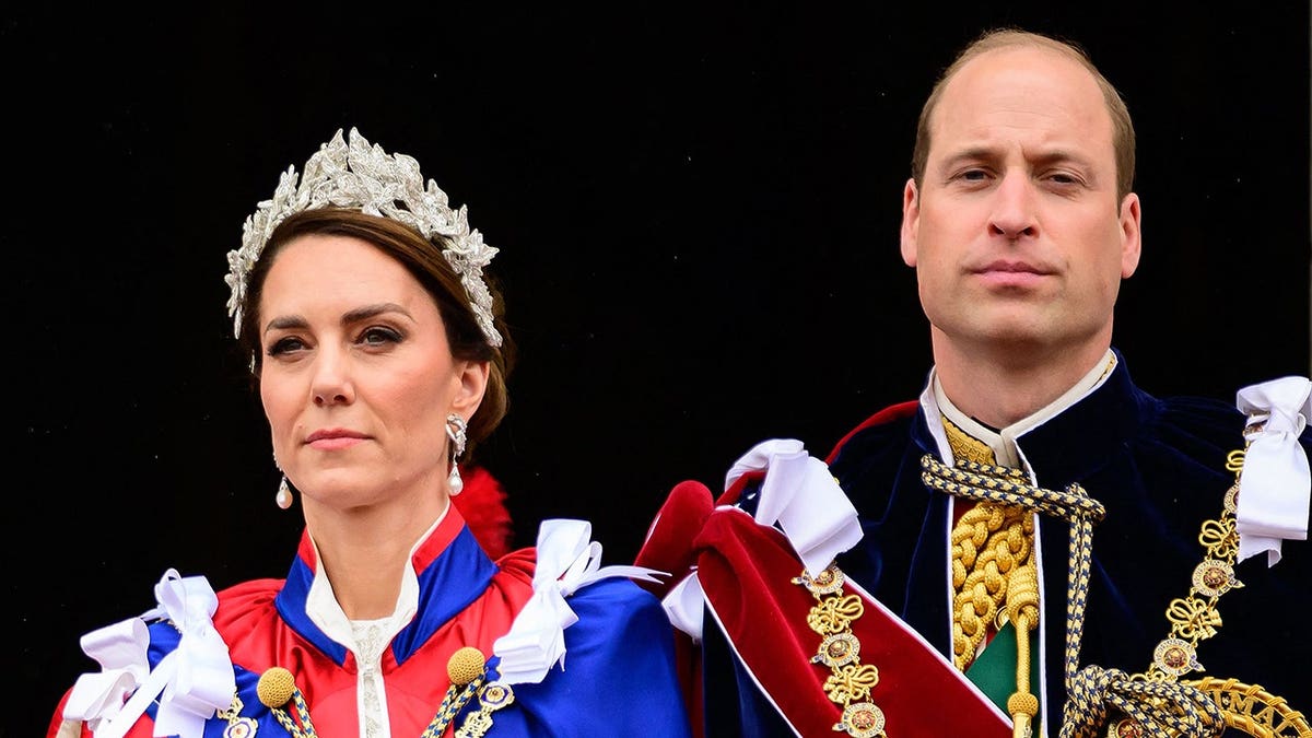 Britain's Prince William and Catherine, Princess of Wales, standing on Buckingham Palace balcony in London