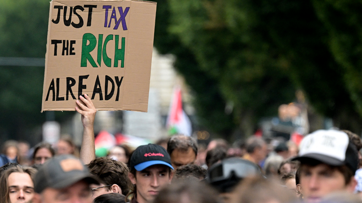 A sign being held up at a protest