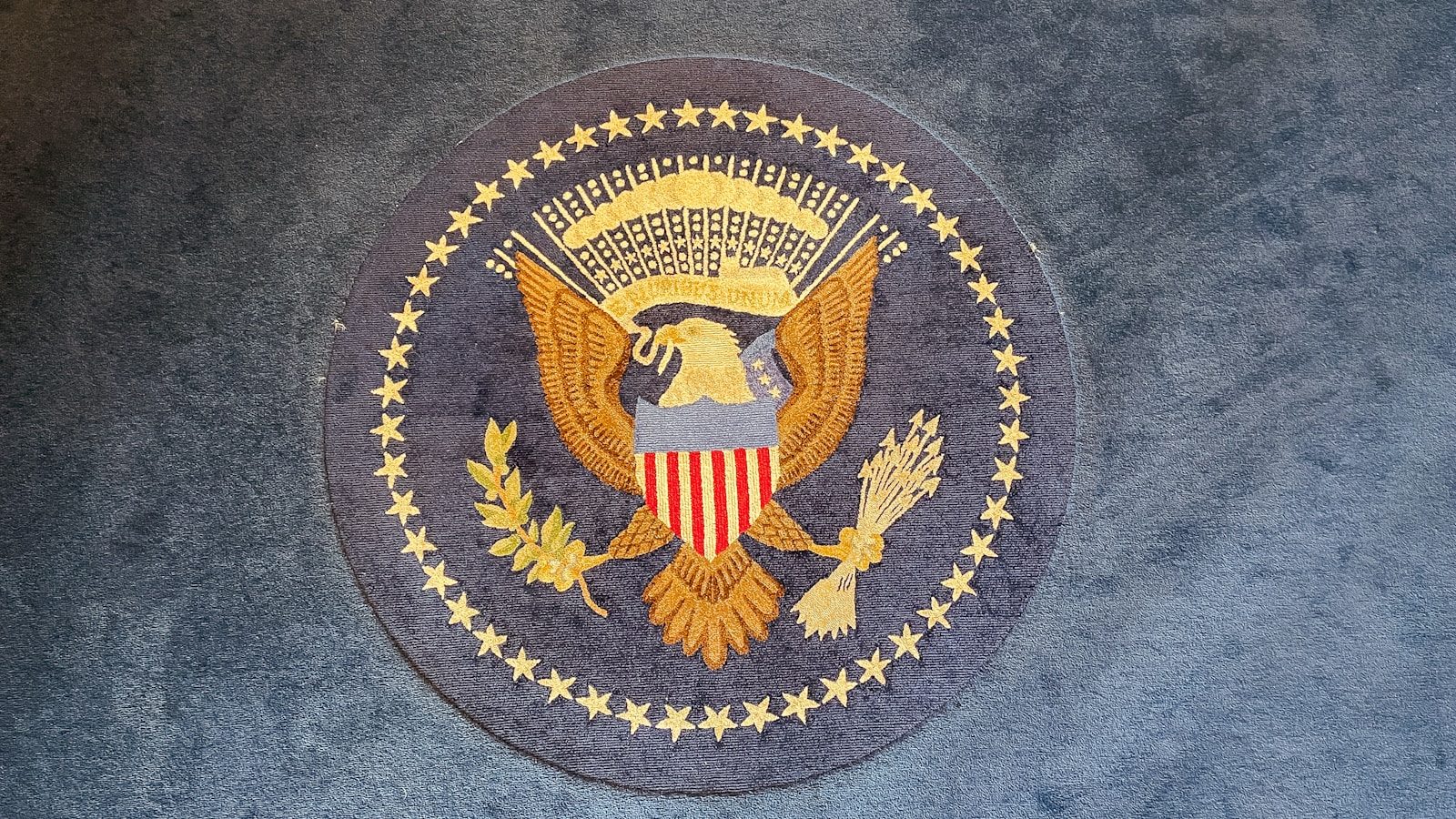 The great seal of the united states on a rug.