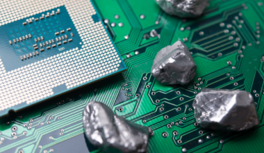 An electronic chip with small rock-like items on it.