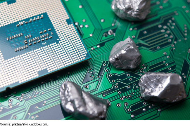 An electronic chip with small rock-like items on it.