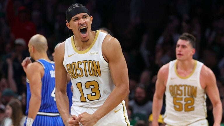 Boston Celtics Ron Harper Jr. #13 reacts after teammate Baylor Scheierman #55 made a three point basket against the Orlando Magic during third quarter NBA action at TD Garden on Saturday April 12, 2026.