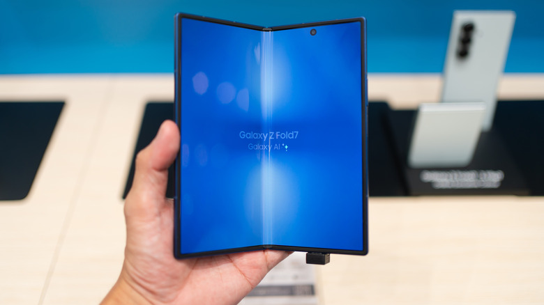 The logo of the Samsung Galaxy Z Fold7 shown on its display in a half-folded state