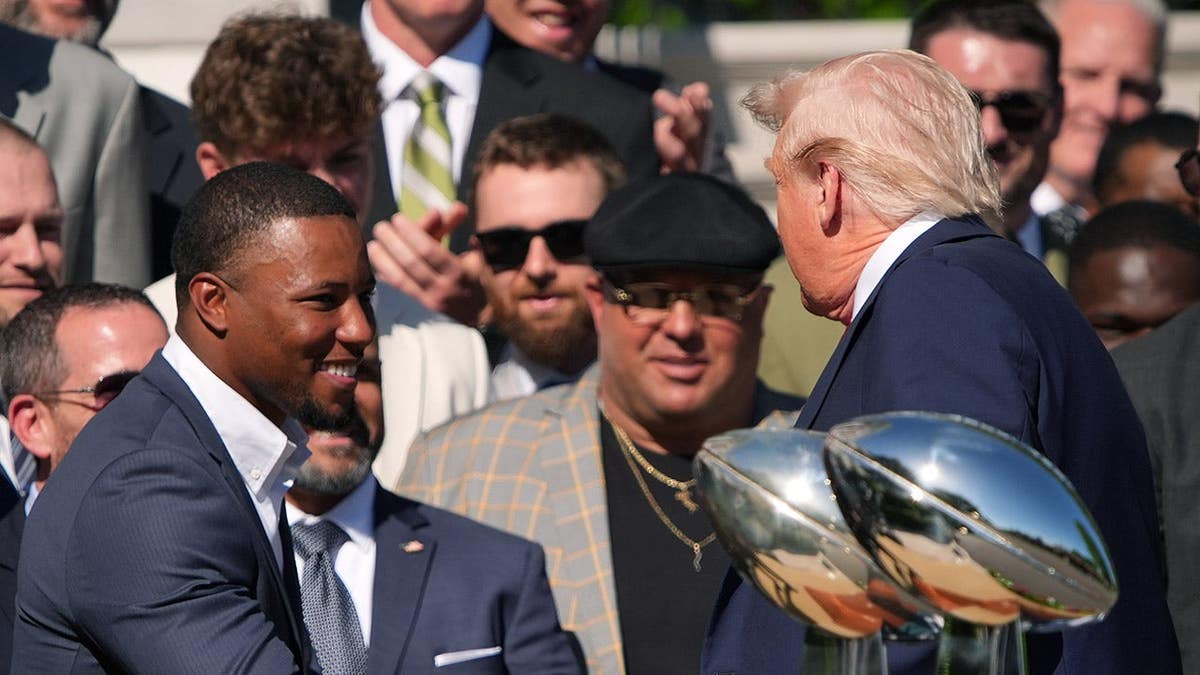 Donald Trump greets Saquon Barkley and Nick Sirianni on the White House lawn.