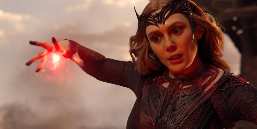 Actor Elizabeth Olsen as the Scarlet Witch, grimacing while performing magic in Doctor Strange in the Multiverse of Madness