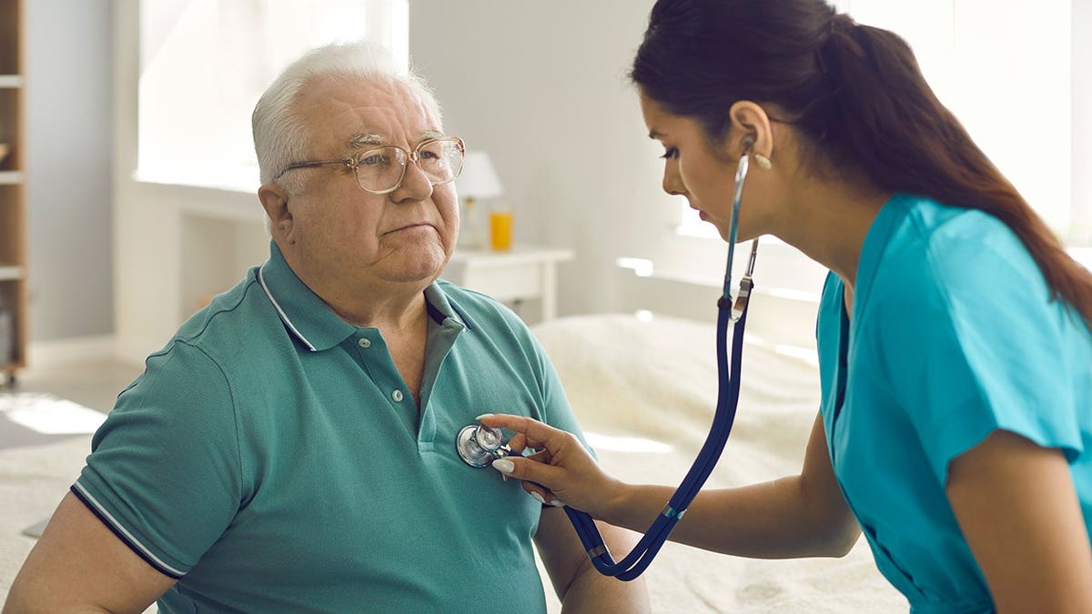 senior man heart checked by nurse