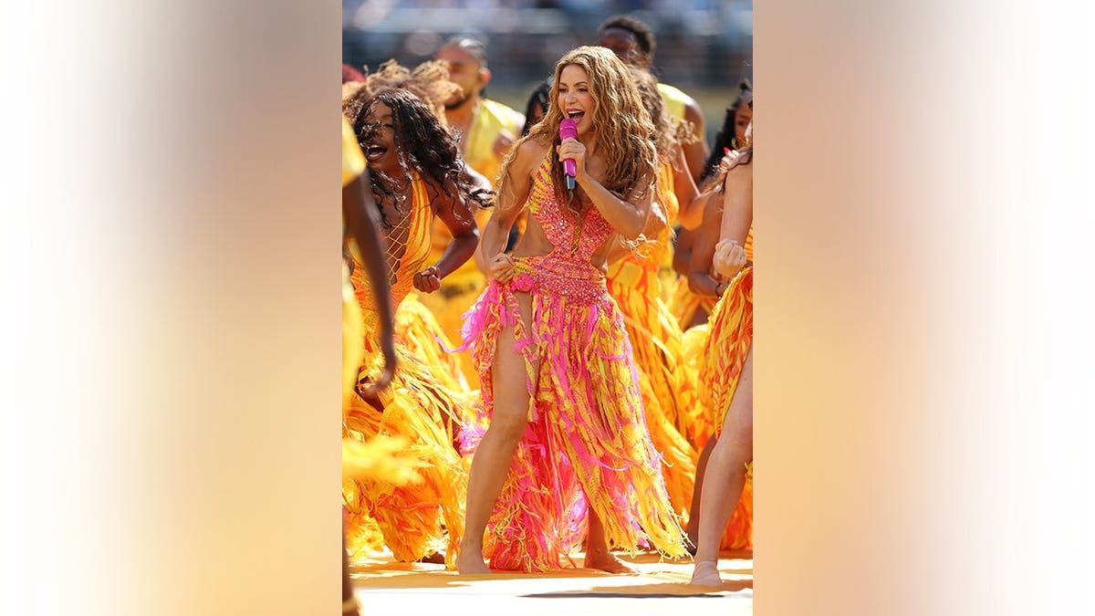 Shakira performs onstage during a halftime show.