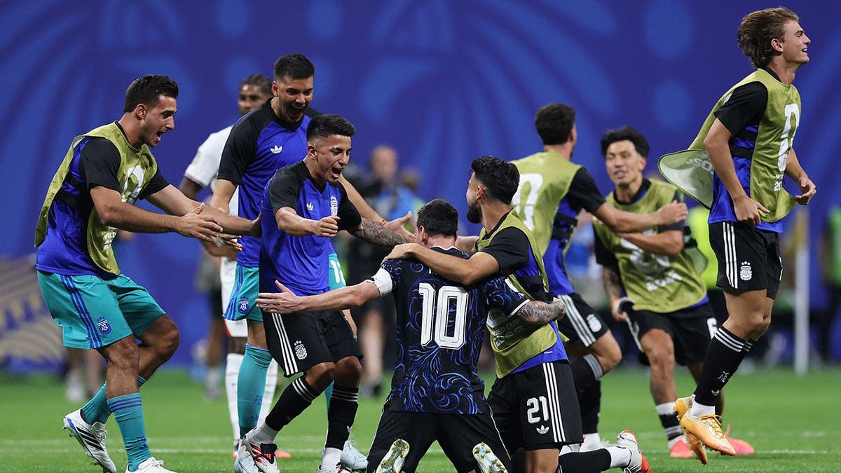 Lionel Messi celebrates with teammates on the field in Atlanta.