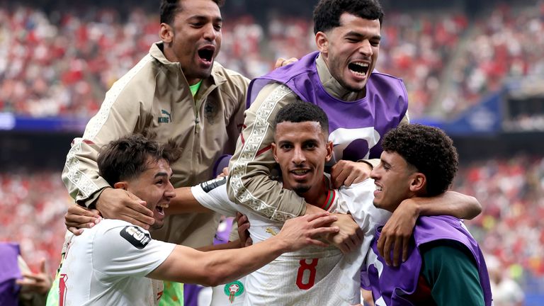 Morocco 's Azzedine Ounahi (C) celebrates with team-mates after scoring their second goal