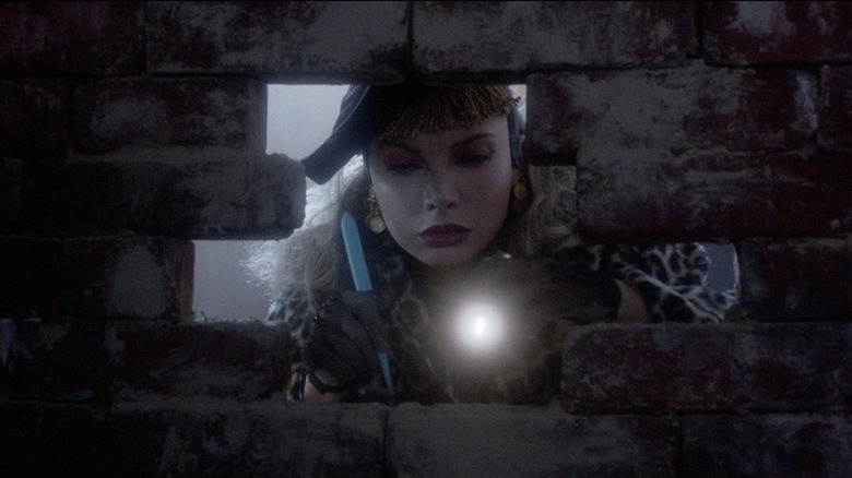 Sammy looking through a hole in a brick wall in Slaughterhouse Rock