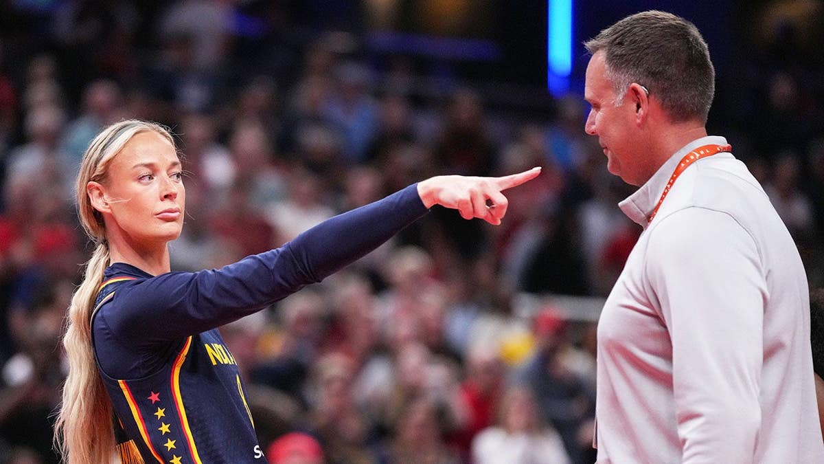 Indiana Fever guard Sophie Cunningham pointing at Phoenix Mercury forward-guard DeWanna Bonner during a basketball game.