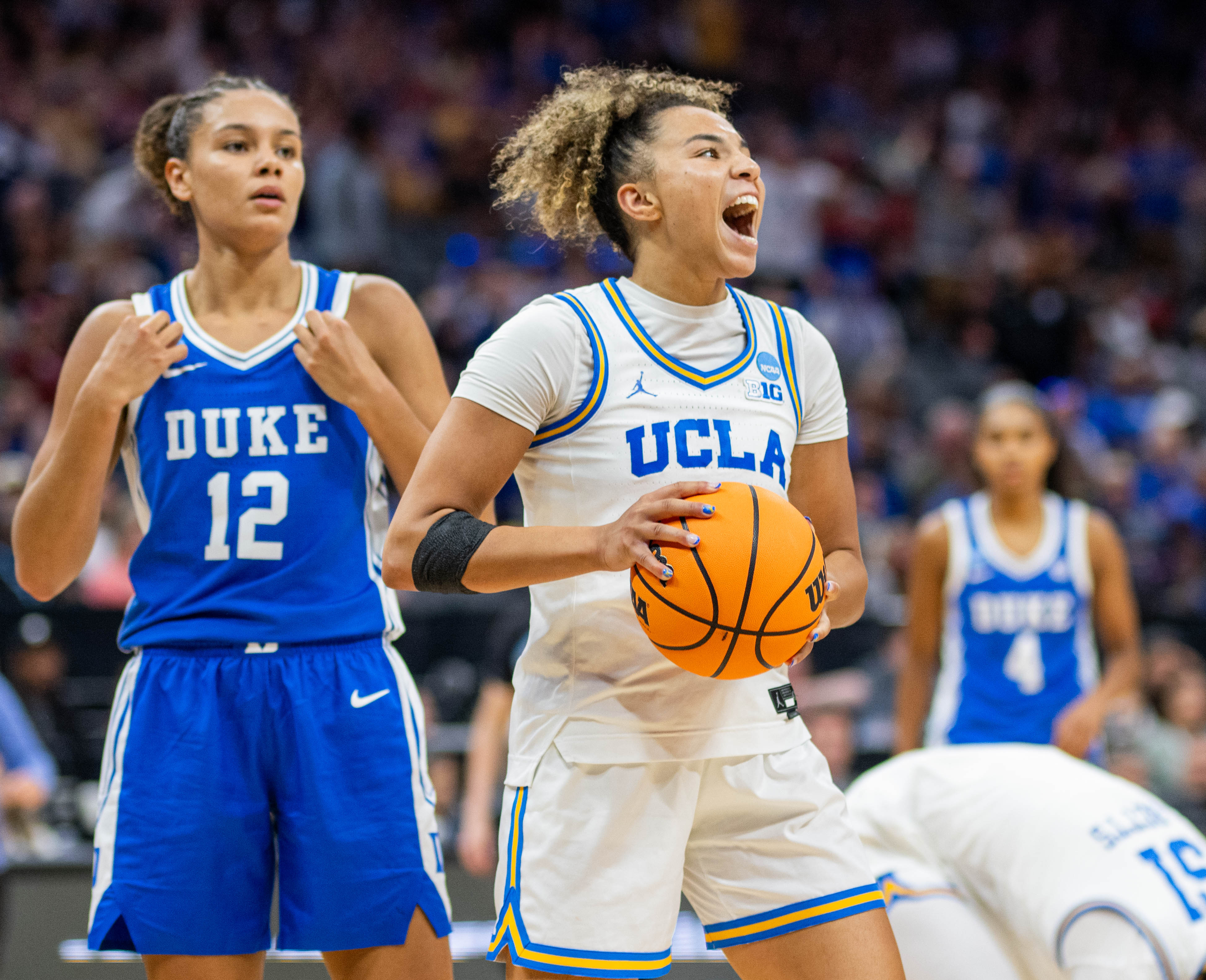 Former Bruin guard Kiki Rice holds the ball and cheers. Rice plays for the Toronto Tempo after being the franchise's first-ever WNBA Draft selection. (Andrew Ramiro Diaz/Photo editor)