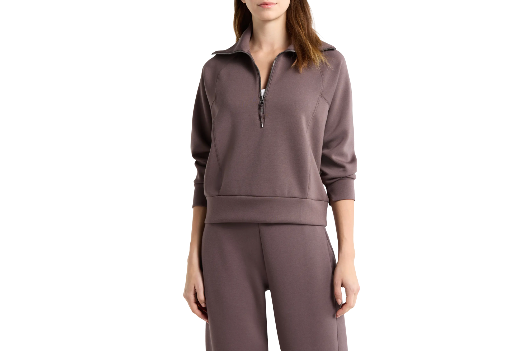 Woman wearing a brown half-zip sweatshirt and matching pants.