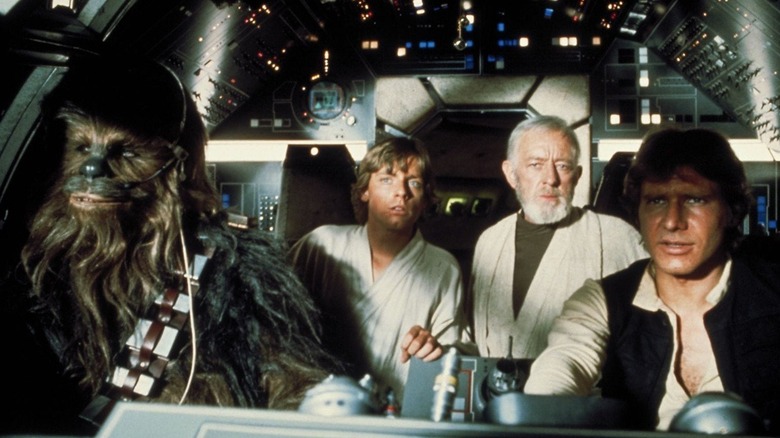 The main cast of Star Wars in the Millennium Falcon cockpit (1977)