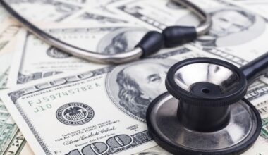 Black stethoscope close-up on top of Dollar banknotes side view