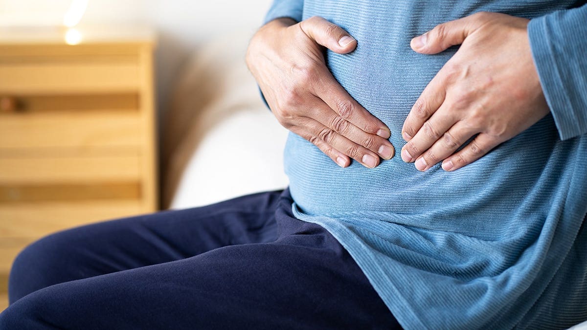 Man holding stomach