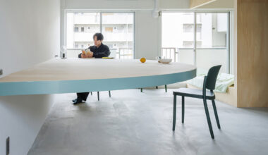 giant blue-green semicircular table by tato architects reorganizes kyoto apartment