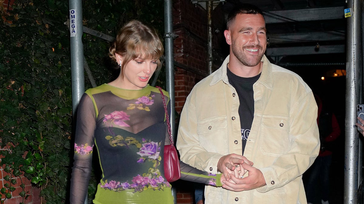 Taylor Swift and Travis Kelce hold hands