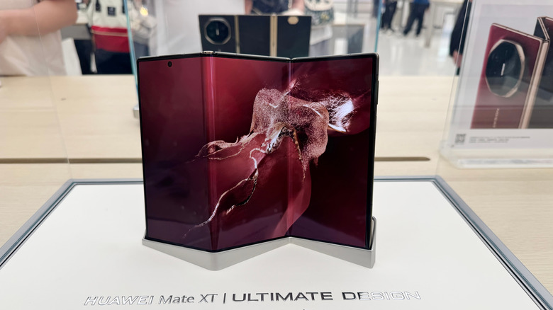 Huawei tri-folding smartphone on display.