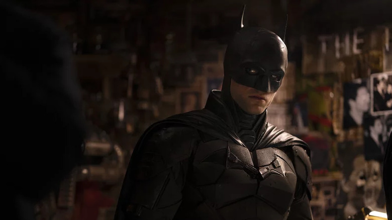 The Caped Crusader looking emo surrounded by a wall of evidence in The Batman